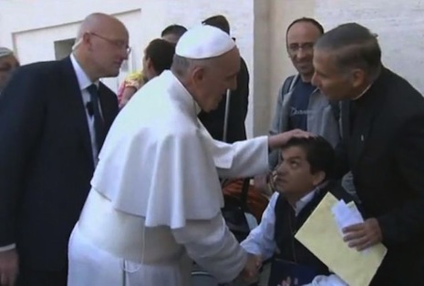 <p>A video still shows Pope Francis praying over a disabled man earlier this month alleged to have been possessed by demons</p>