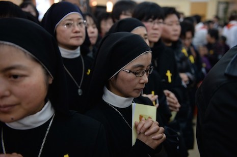<p>Nuns offer prayers at the funeral of the late head of the underground Catholic Church in Shanghai, underground Bishop Joseph Fan Zhongliang of Shanghai, on March 22, 2014. An increasingly secularized environment is among the factors leading to a drop in vocations in China and elsewhere. (Photo: AFP/Peter Parks)</p>