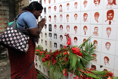 <p>A Tamil woman cries after offering a floral tribute to relatives who disappeared during Sri Lanka's civil war. (Photo by Quintus Colombage)</p>