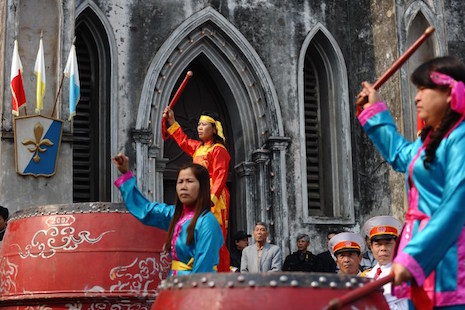 <p>Catholics beat drums during a welcoming ceremony at a cathedral in Hanoi in January. (Photo by Hoang Dinh Nam/AFP)</p>