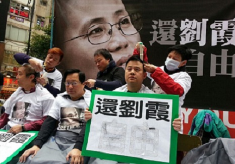 Hong Kong protesters shave heads to support dissidents