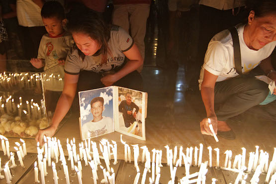 Relatives hold candle-lit vigil for Philippine drug war dead