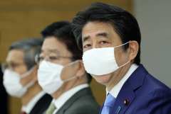 Japan extends emergency as health system strains