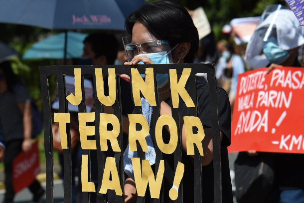 Philippine police accost terror law opponents at Mass 