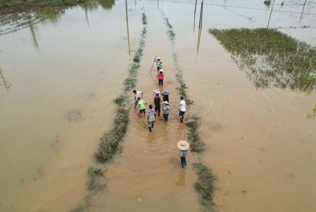 This aerial photo taken on July 6 shows residents clearing a flooded street after heavy rains caused by typhoon Chaba, in Yingde, Qingyuan city, in China's southern Guangdong province
