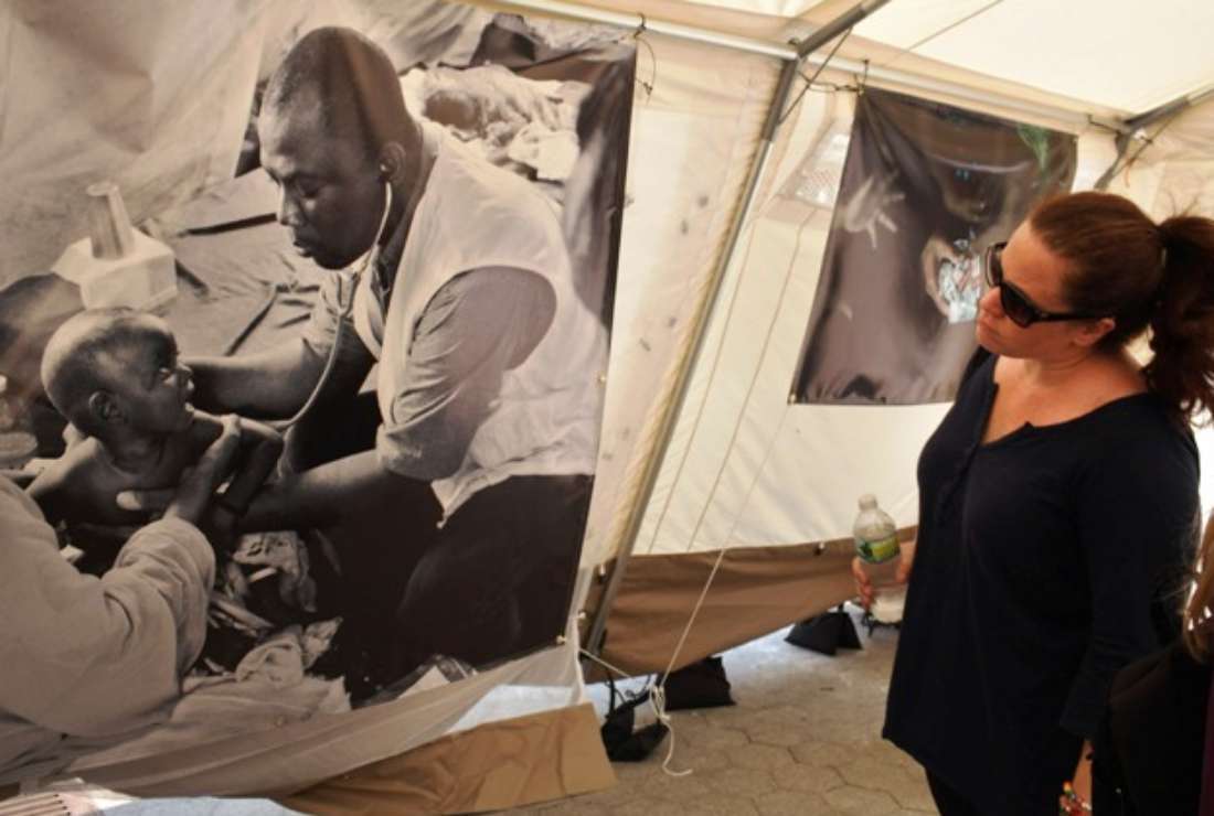 A visitor to 'Starved for Attention,' a free interactive exhibit by Doctors Without Borders/Medecins Sans Frontieres (MSF) in Union Square, in New York Citylooks at photographs that focus on the topic of childhood malnutrition, in New York City on Sept. 13, 2011