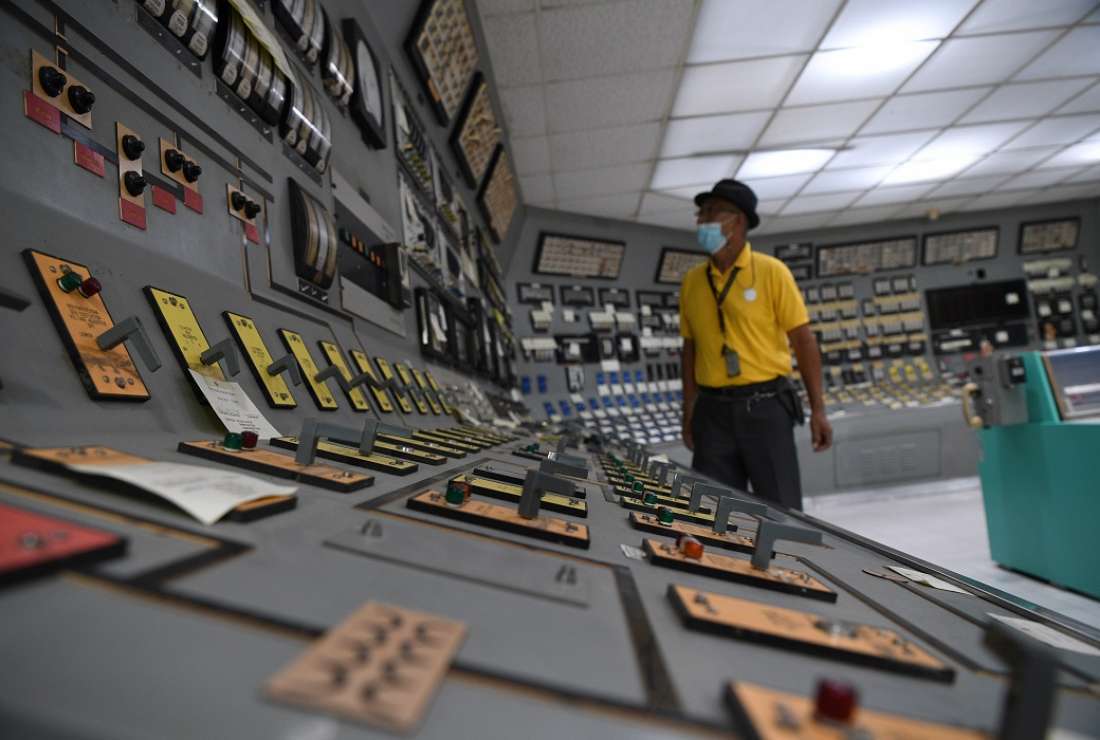 This photo taken on April 5, 2022 shows an employee checking switches inside the control room at the Bataan Nuclear Power Plant in the town of Morong in Bataan province, north of Manila, in the Philippines