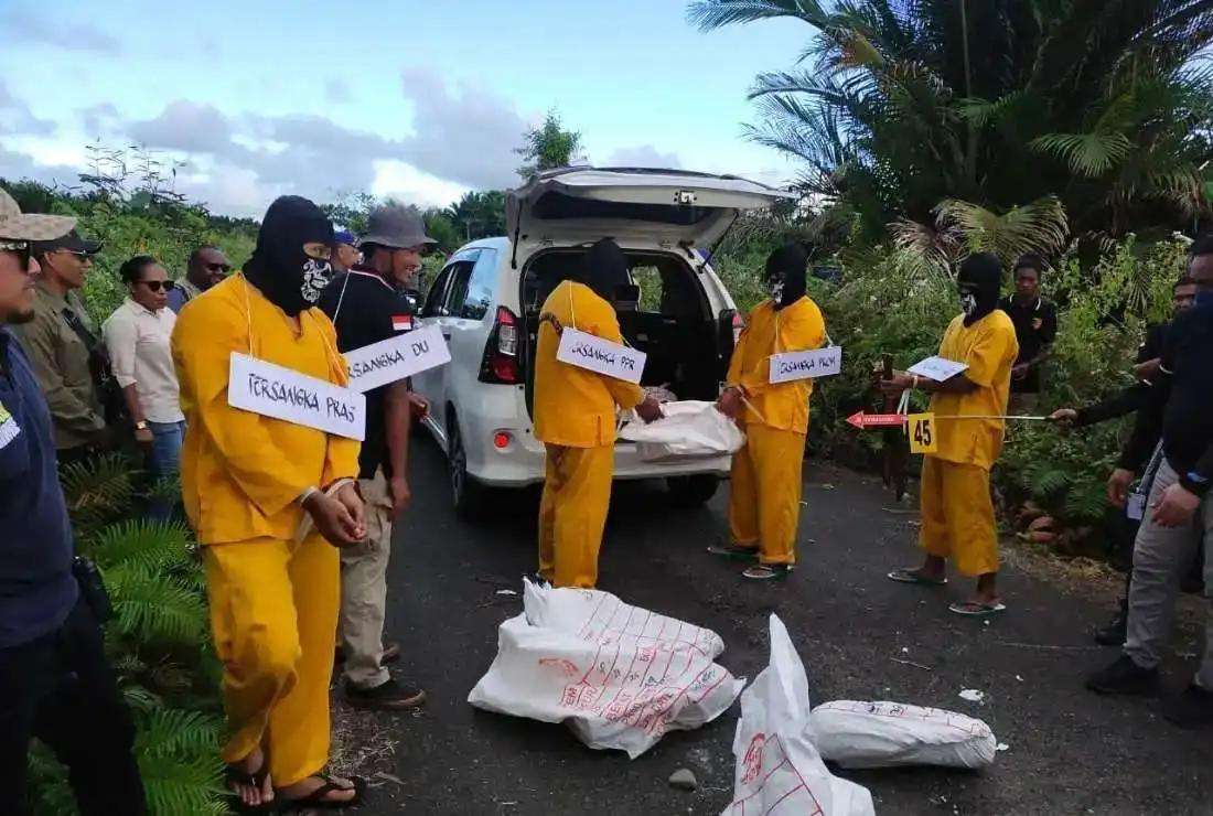A group of activists is seen reconstructing the crime scene of the killing of four Protestant Christians in Papua province in Indonesia