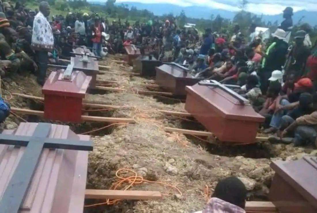 Residents bury the bodies of victims who were shot dead by police during the riots in Indonesia's Papua Province on Feb. 25