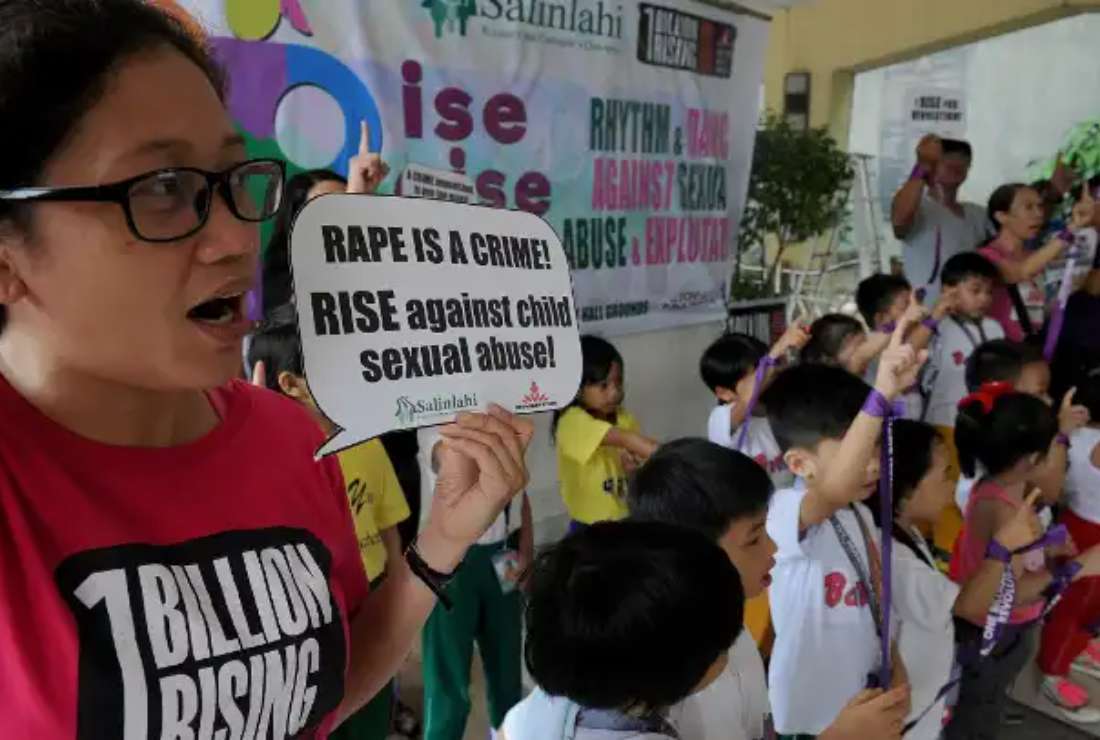 Filipino women and children take part in a dance exercise in Manila to draw attention to child sexual abuse
