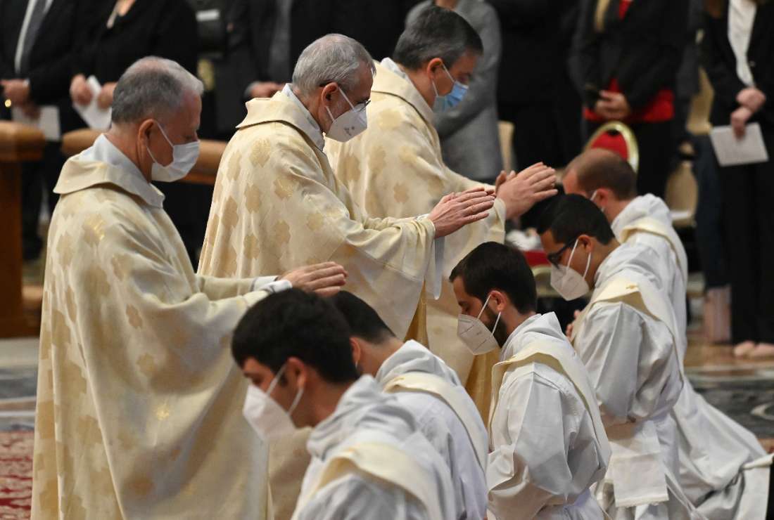 Deacons go through the laying-on of hands ritual during an ordination Mass on April 25, 2021, in St. Peter's Basilica at The Vatican, during which the pope ordained nine priests for his diocese as bishop of Rome