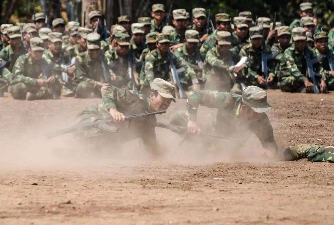 In this photo taken on March 8, 2023 members of the ethnic rebel group, the Ta'ang National Liberation Army (TNLA), take part in a training exercise at their base camp in a forest in Myanmar's Shan State. At least 30 civilians have been killed in fighting between junta troops and rebel groups in the state in recent weeks according to a rights group