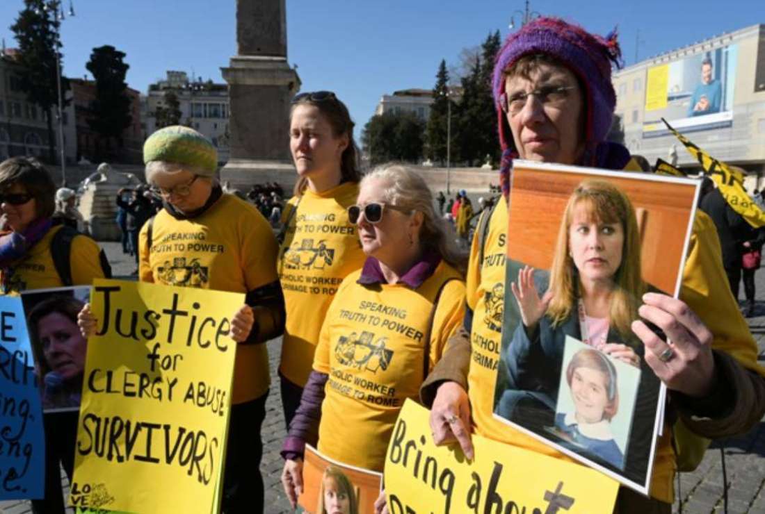Members of Ending Clergy Abuse (ECA), a global organization of prominent survivors and activists in Rome for a papal summit, display photos of Barbara Blaine, the late founder and president of Survivors Network of those Abused by Priests (SNAP), during a protest of abuse victims on the Piazza del Popolo in Rome on Feb. 23, 2019
