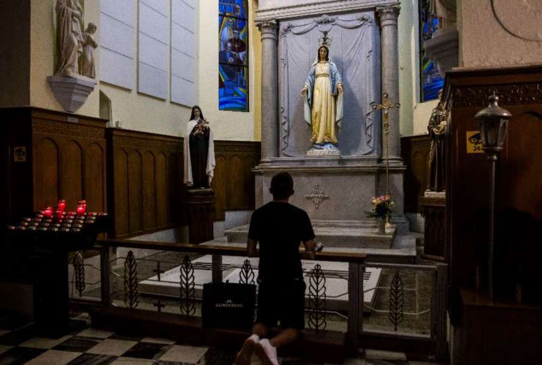 A man prays in a Catholic church in Hong Kong on May 12, 2022. 