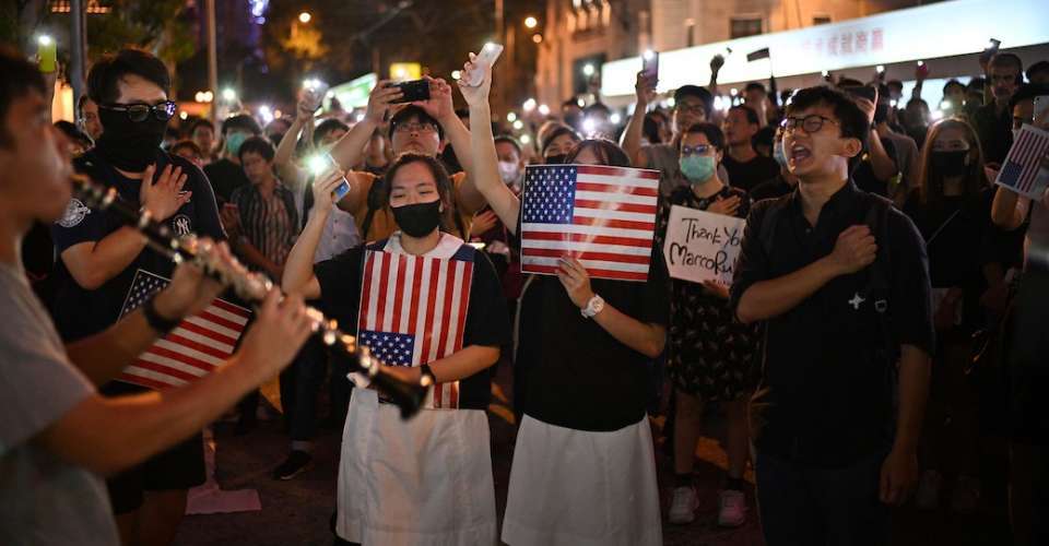 Protesters sing the Glory to Hong Kong at a rally in Hong Kong on Oct. 14, 2019, calling on US politicians to pass a bill that could alter Washington's relationship with the trading hub.